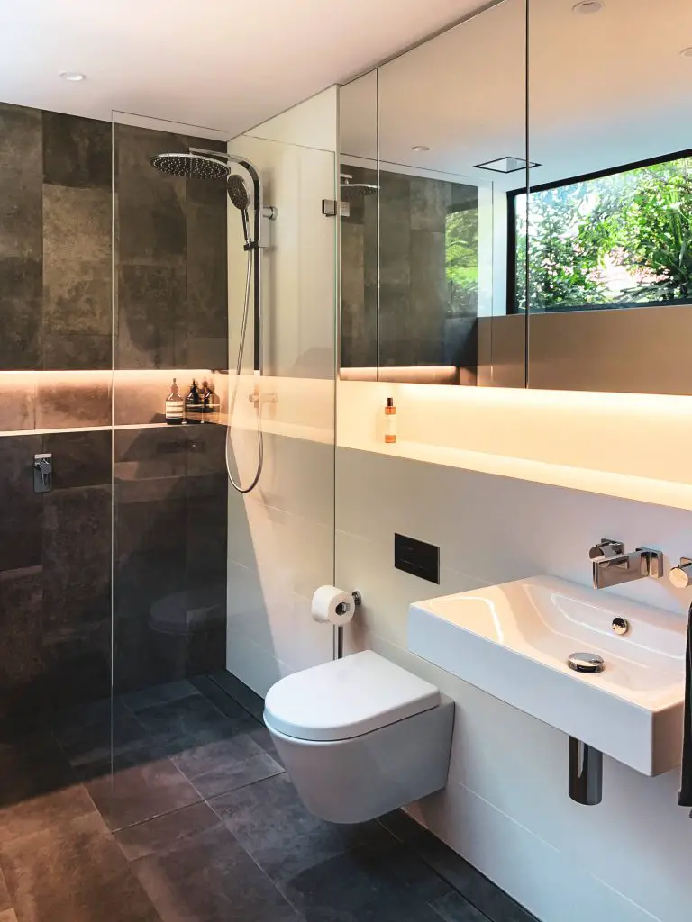 Inspiration for a contemporary gray tile and white tile gray floor bathroom remodel in Sydney with a wall mount toilet, white walls and a wall mount sink