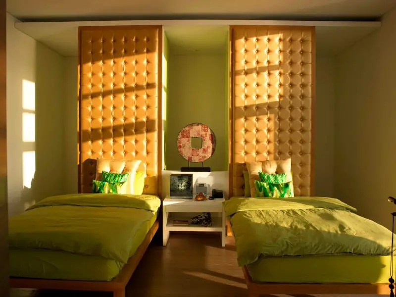 Inspiration for a contemporary guest medium tone wood floor bedroom remodel in Other with green walls and no fireplace.