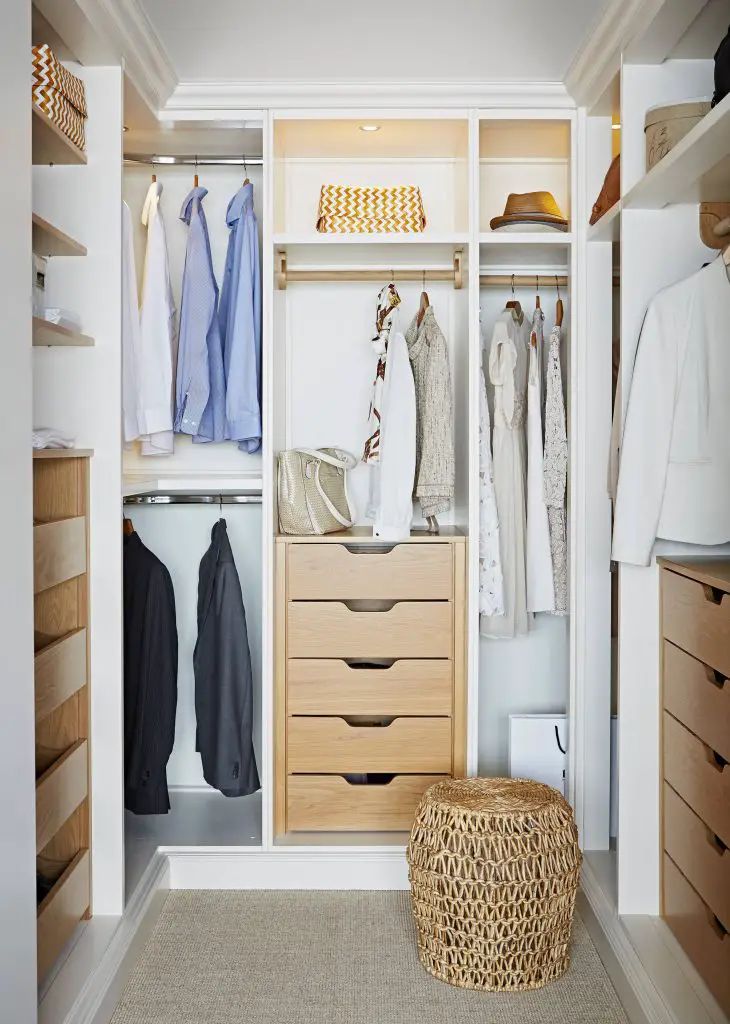 Most popular closet (2) White and wood is a popular combination, and this closet shows why. Oak drawers contrast crisp white cabinetry and complement the natural texture of the footstool. This closet is about 10 feet long and 8 feet wide.