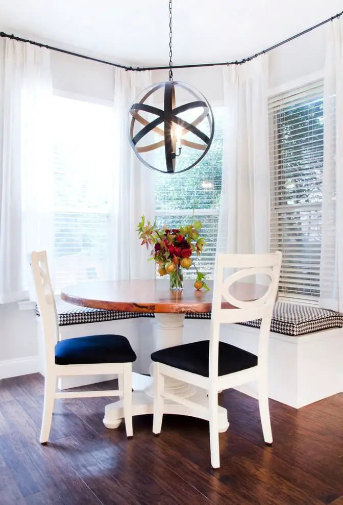 The circular pendant from Shades of Light adds sculptural interest to this Austin, Texas, breakfast area