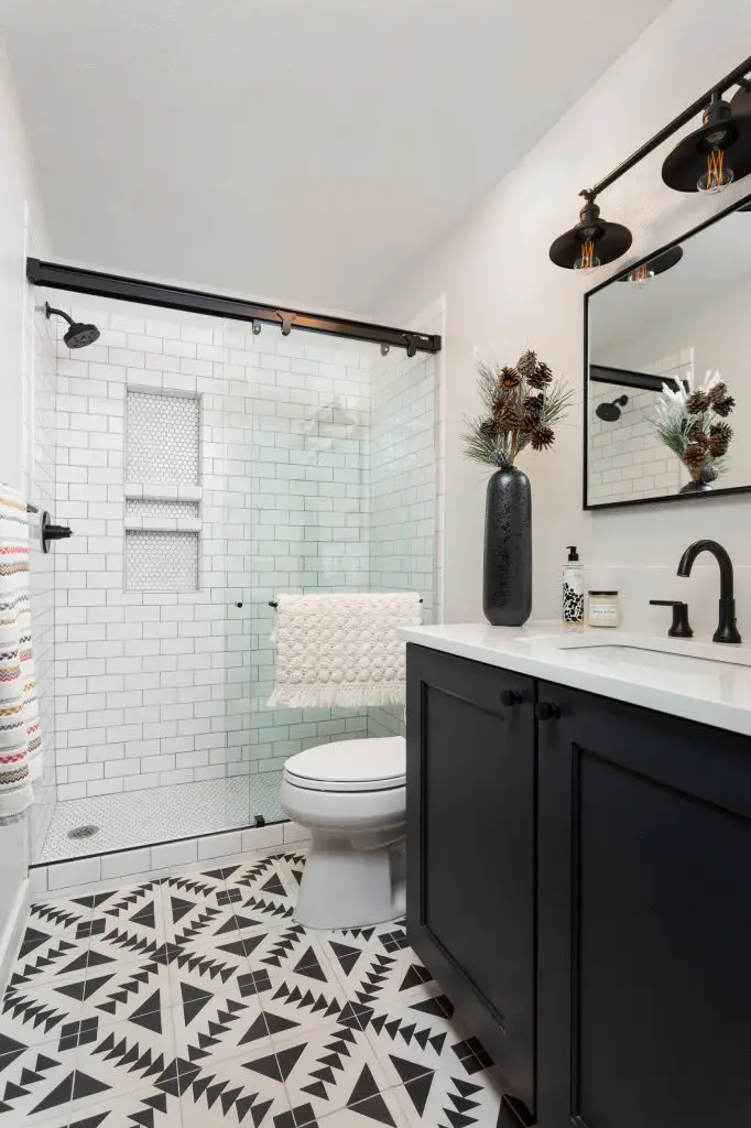 Transitional white tile and subway tile multicolored floor bathroom photo in Denver with shaker cabinets, black cabinets, white walls, an undermount sink and white countertops