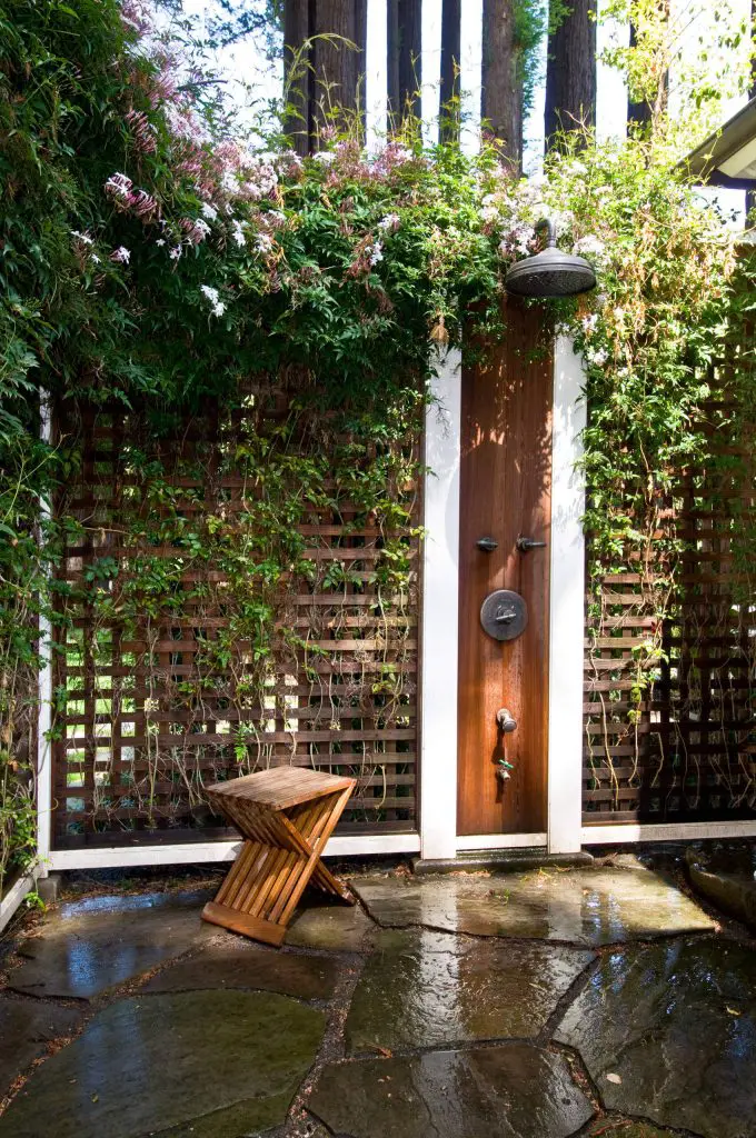 Outdoor shower set into a trellis fence in San Francisco