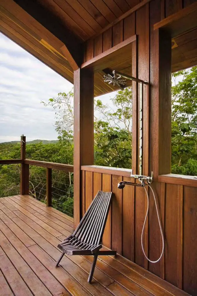 Outdoor shower with lush views of the tropical forest below